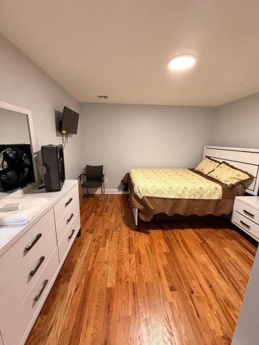 a bedroom with a bed and a television in it at E&G homes in East Orange