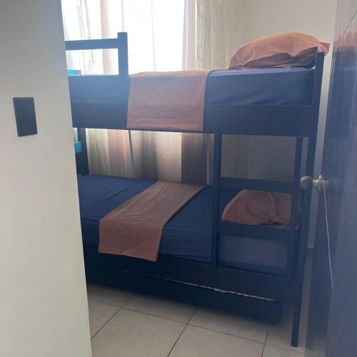 two bunk beds in a room with a window at Apartamento Ocean View in La Chumicosa