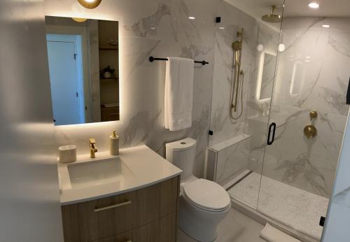 a bathroom with a toilet and a shower and a sink at Paradise on the Lake in Kelowna