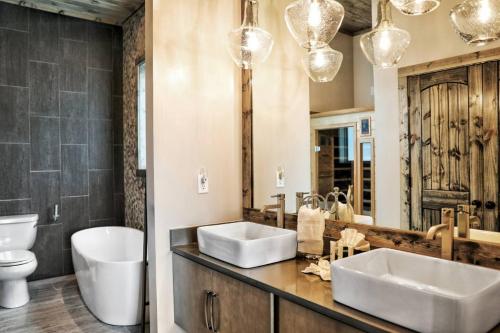 a bathroom with two sinks and a toilet and a mirror at Million Dollar Mountain Views in Gatlinburg