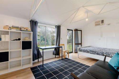 a bedroom with a bed and a desk at Cute and cozy cottage in Northfield