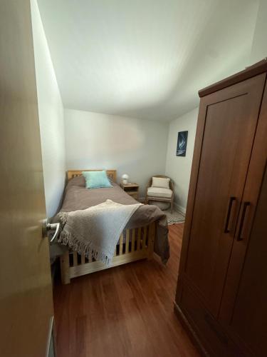 a small bedroom with a bed in a attic at The Hanson Hideaway in Whitehorse