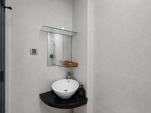 a bathroom with a white sink and a mirror at GALANG HOTEL in Ho Chi Minh City