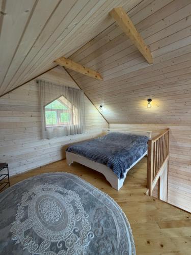 a bedroom with a bed in a wooden cabin at Forest Hills in Yaremche