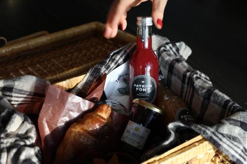 a basket with a bottle of wine and bread at La Maison Karuizawa in Karuizawa