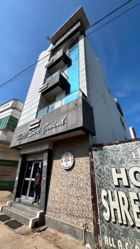a man standing in the doorway of a building at Hotel shree govind in Orai