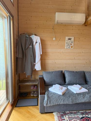 a living room with a couch and a clothes rack at Forest Hills in Yaremche