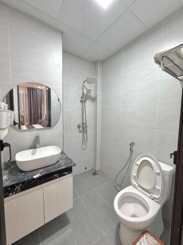 a bathroom with a toilet and a sink and a shower at Lamer Hostel in Cat Ba
