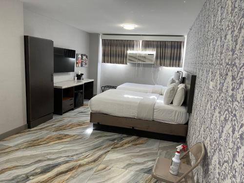 a hotel room with a bed and a desk at The Essence Hotel at JFK in Jamaica