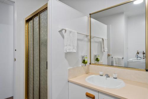 a bathroom with a sink and a mirror at Myrtleford Holiday Park in Myrtleford