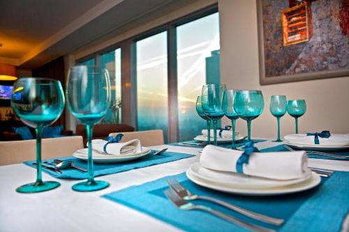 a table with plates and wine glasses on it at Andersia Hotel & Spa Poznan, a member of Radisson Individuals in Poznań