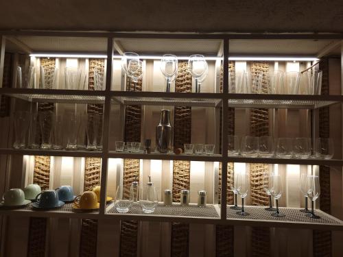 a shelf filled with wine glasses in a wine cellar at Casa Tayrona Suites in Medellín