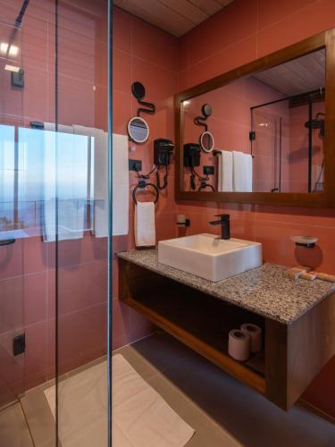 a bathroom with a sink and a mirror at Villa Cavo - Beneath the Misty Peaks in Haputale