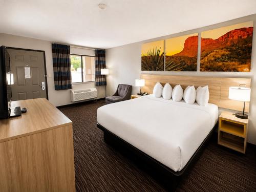 a hotel room with a bed and a television at Days Inn by Wyndham Rio Rancho in Rio Rancho