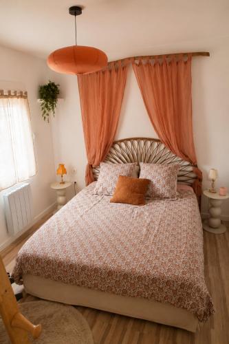 a bedroom with a bed with an orange canopy at Le Nid des Wallabys in Monchy-le-Preux