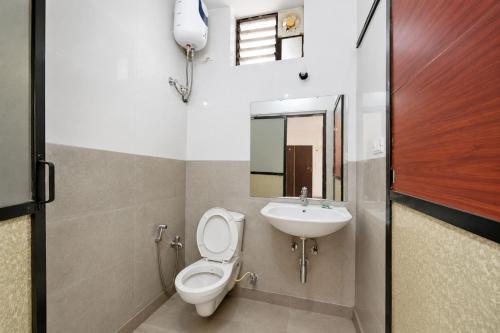 a bathroom with a toilet and a sink at Sunlight Stay at Goa in Calangute