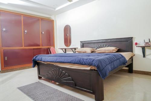 a bedroom with a bed with blue sheets and pillows at My3 rooms in Vijayawāda