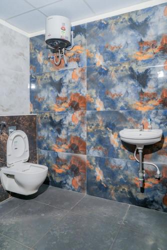 a bathroom with a toilet and a sink at My3 rooms in Vijayawāda