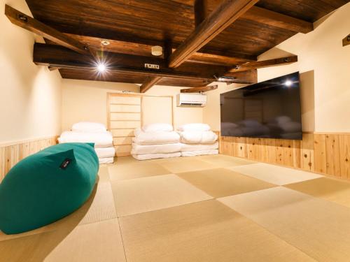 a room with a flat screen tv and a bean bag chair at 奈良旅館 VILLA East West in Nara