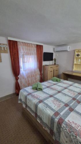 a bedroom with a bed and a window at Olga 112 in Bar