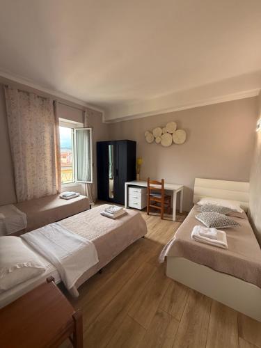 a hotel room with two beds and a table at Panoramic Apartment 5Terre La Spezia in La Spezia