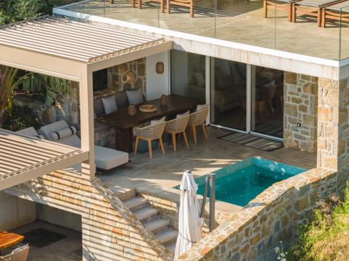 an external view of a house with a swimming pool at Gialova Hills - Luxury Villa with Private Pool, Sauna, Garden & Seaview in Gialova