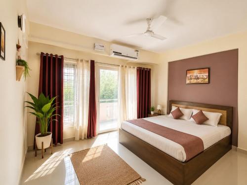 a bedroom with a bed and a large window at Aura Vista in Bhopal