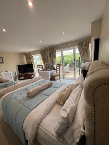 a large bedroom with a large bed in a room at Highcroft House in Corsham