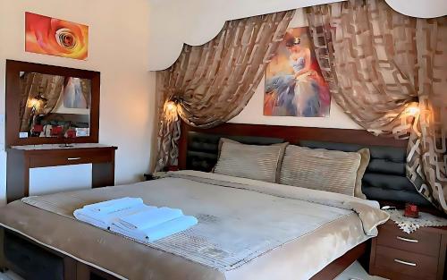 a bedroom with a large bed and a mirror at Relax pozar in Kato Loutraki