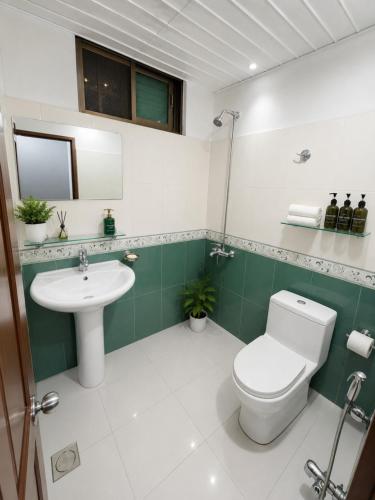 a bathroom with a toilet and a sink at Canopy Court Farmhouse Murree in Bhurban