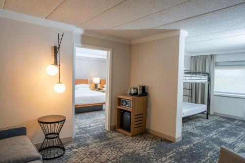 a hotel room with a bed and a living room at Sheraton Niagara Falls in Niagara Falls