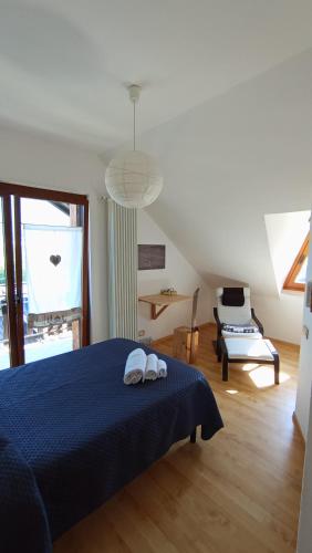 a bedroom with a blue bed with two towels on it at LA ROCCA BIANCA in Demonte