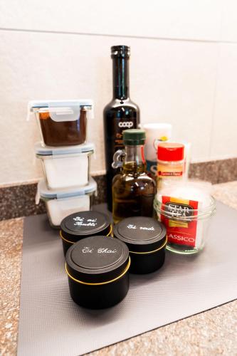 a counter with three bottles of alcohol and other ingredients at Dolomitihouse NOGHERA in Fiera di Primiero