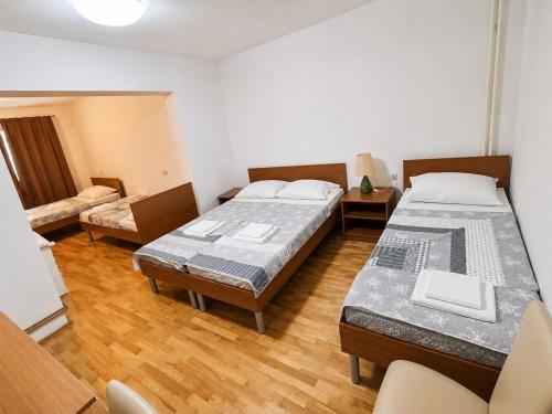 a room with two beds and a couch at Rooms Ava Raj in Međugorje