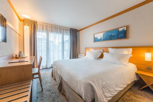 Кровать или кровати в номере Hotel Le Morgane