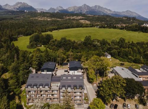 an aerial view of a building with mountains in the background at Apartmán Forest, Tatranská Štrba in Tatranska Strba