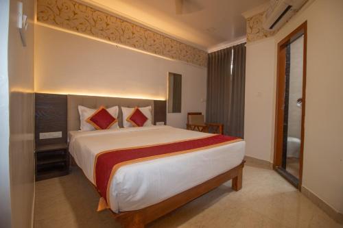 a bedroom with a large bed in a room at Hotel Town Palace in Shimoga