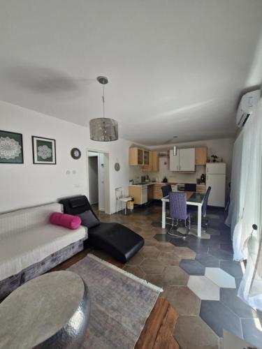 a living room with a couch and a table at Little Aria in Ripač