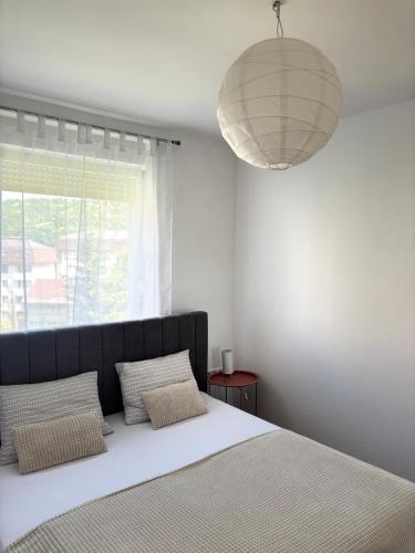 a bedroom with a large bed and a large window at Lena in Jajce