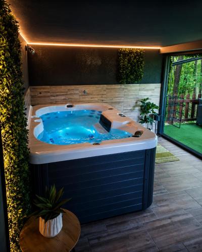 a large jacuzzi tub in a room with at Vila Šibovi in Banja Luka