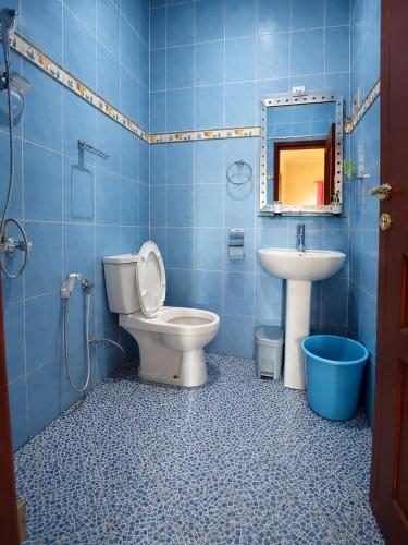 ein blaues Badezimmer mit Toilette und Waschbecken in der Unterkunft Appartement in Moroni