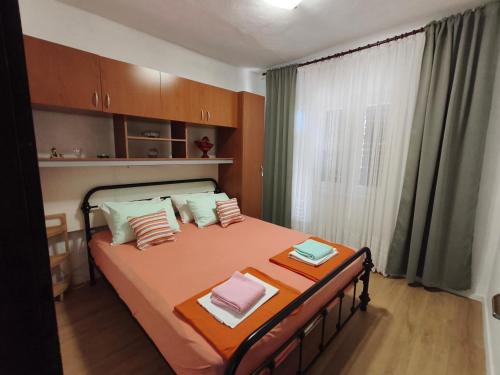 a bedroom with a bed with two towels on it at Luminaria Solis kuća za odmor in Rogoznica