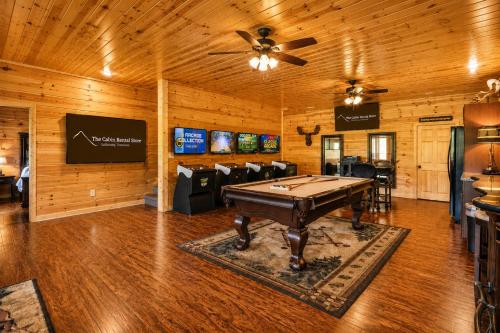 a game room with a pool table and chairs at Greenbrier Estate in Pittman Center