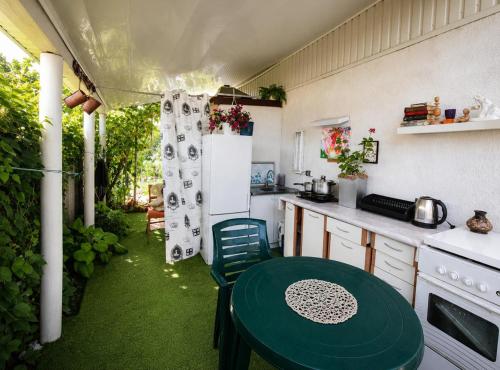 a kitchen with a green table and a refrigerator at Лана бугаз in Karolino-Buhaz