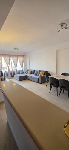 a living room with a couch and a table at Mista apartment in Peyia