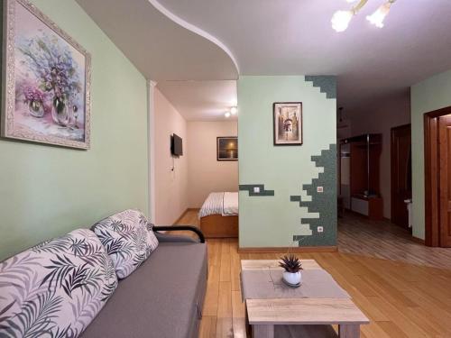 a living room with a couch and a table at Private Apartment in Morshin