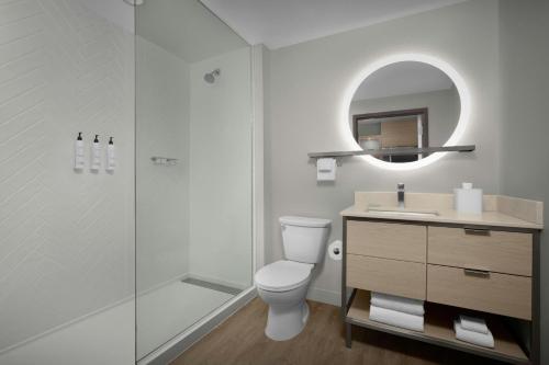 a bathroom with a shower and a toilet and a sink at TownePlace Suites by Marriott Palmdale in Palmdale