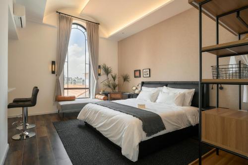 a bedroom with a bed and a large window at Hanachi Stay in Ho Chi Minh City
