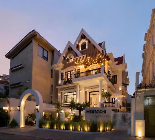 a large house with lights in front of it at Hanachi Stay in Ho Chi Minh City