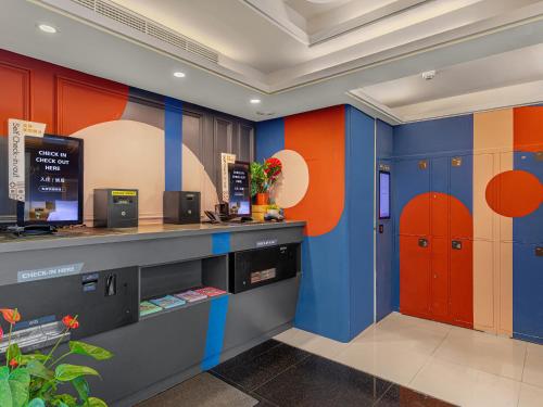 a restaurant with colorful walls and orange and blue at Guide Hotel Taipei Xinyi in Taipei